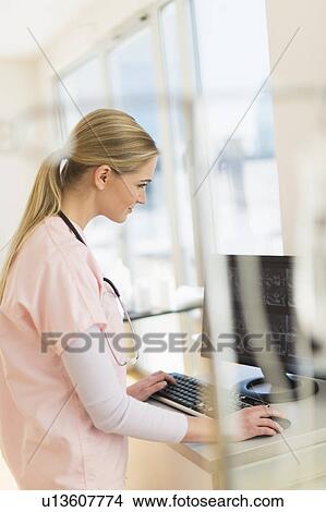 Female nurse working on computer View Large Photo Image Picture - Female nurse working on computer. Fotosearch