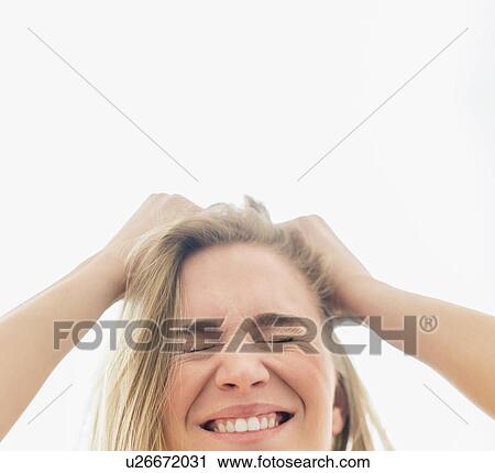 Stock Image - Frustrated woman pulling hair. Fotosearch