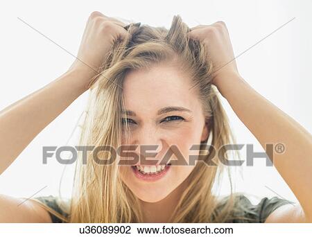 Stock Image - Frustrated woman pulling hair. Fotosearch