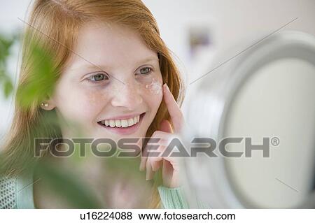 Girl (12-13) applying moisturizer View Large Photo Image Stock Photo - Girl (12-13) applying moisturizer. Fotosearch