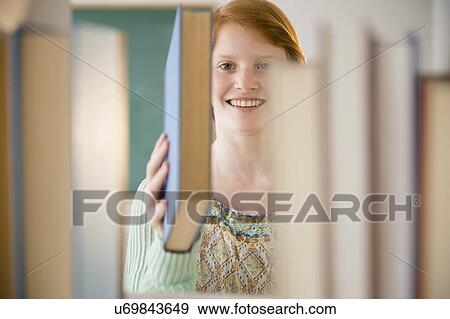 Stock Photo - Girl (12-13) in library. Fotosearch