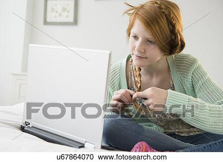 Girl (12-13) using laptop View Large Photo Image Stock Image - Girl (12-13) using laptop. Fotosearch