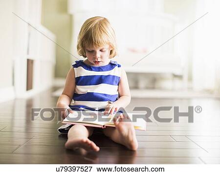 Girl (4-5) reading book View Large Photo Image Stock Photo - Girl (4-5) reading book. Fotosearch