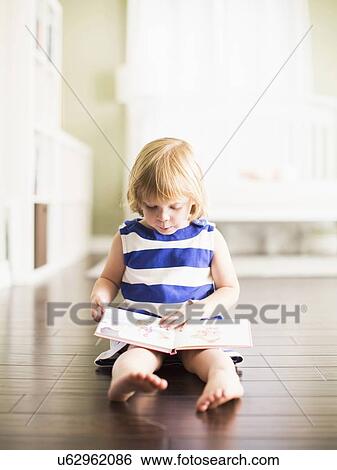 Girl (4-5) reading book View Large Photo Image Stock Photograph - Girl (4-5) reading book. Fotosearch