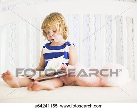 Girl (4-5) reading book View Large Photo Image Stock Photography - Girl (4-5) reading book. Fotosearch