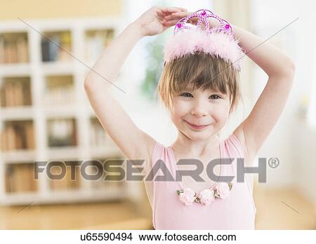 Girl (4-5) wearing tutu dancing in living room View Large Photo Image Picture - Girl (4-5) wearing tutu dancing in living room. Fotosearch