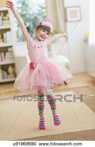 Girl (4-5) wearing tutu dancing in living room View Large Photo Image Stock Image - Girl (4-5) wearing tutu dancing in living room. Fotosearch