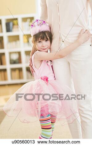 Girl (4-5) wearing tutu holding onto mother View Large Photo Image Stock Image - Girl (4-5) wearing tutu holding onto mother. Fotosearch