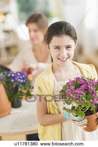 Girl (8-9) and mother potting flowers View Large Photo Image Stock Image - Girl (8-9) and mother potting flowers. Fotosearch