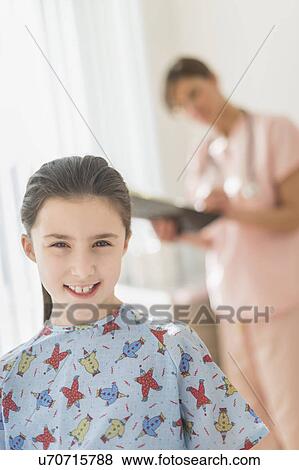 Girl (8-9) in doctor's office View Large Photo Image Stock Photo - Girl (8-9) in doctor's office. Fotosearch