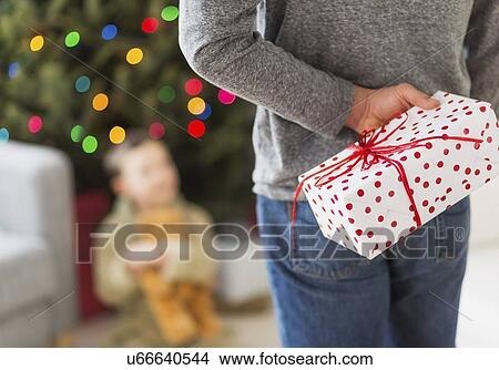 Man holding present View Large Photo Image Picture - Man holding present. Fotosearch