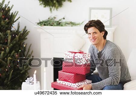 Man holding presents View Large Photo Image Stock Photography - Man holding presents. Fotosearch