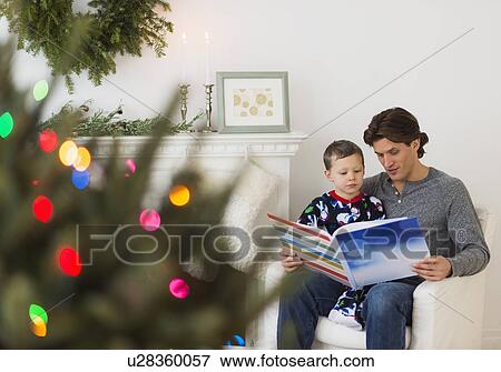 Man reading book with boy (6-7) View Large Photo Image Stock Photo - Man reading book with boy (6-7). Fotosearch