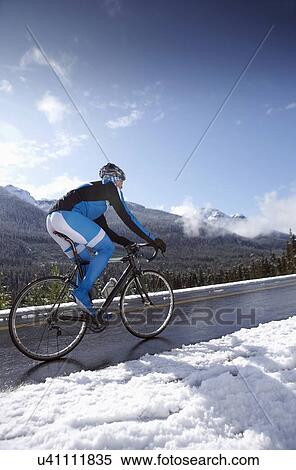 Man riding bike in winter mountains View Large Photo Image Stock Photography - Man riding bike in winter mountains. Fotosearch