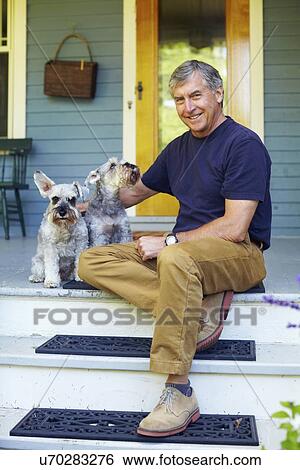 Man with his schnauzers sitting on porch View Large Photo Image Stock Photograph - Man with his schnauzers sitting on porch. Fotosearch