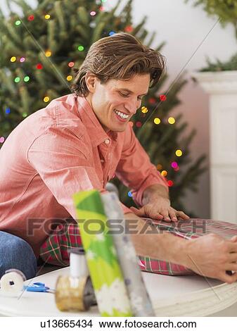 Picture - Man wrapping presents. Fotosearch