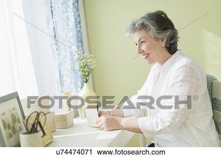 Mature woman writing letter View Large Photo Image Stock Image - Mature woman writing letter. Fotosearch