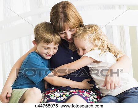 Mother embracing son (8-9) and daughter (6-7) View Large Photo Image Stock Photography - Mother embracing son (8-9) and daughter (6-7). Fotosearch