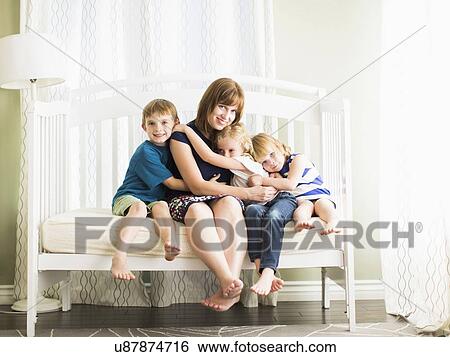 Mother embracing son (8-9) and daughters (4-5, 6-7) View Large Photo Image Stock Photograph - Mother embracing son (8-9) and daughters (4-5, 6-7). Fotosearch