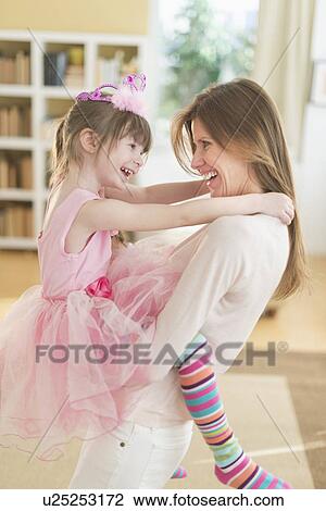 Mother holding daughter (4-5) wearing tutu View Large Photo Image Stock Image - Mother holding daughter (4-5) wearing tutu. Fotosearch