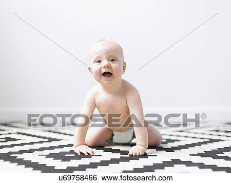 Portrait of baby boy (2-5 months) crawling View Large Photo Image Stock Photograph - Portrait of baby boy (2-5 months) crawling. Fotosearch