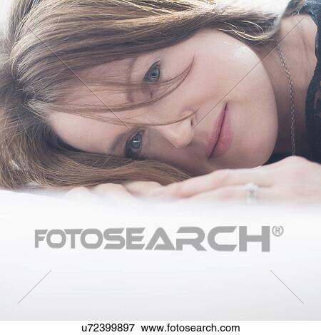 Portrait of beautiful woman lying down View Large Photo Image Stock Photo - Portrait of beautiful woman lying down. Fotosearch