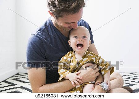 Stock Image - Portrait of father with baby son (2-5 months). Fotosearch