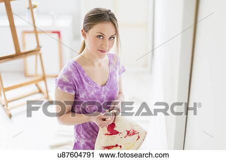 Portrait of female artist in studio View Large Photo Image Stock Image - Portrait of female artist in studio. Fotosearch