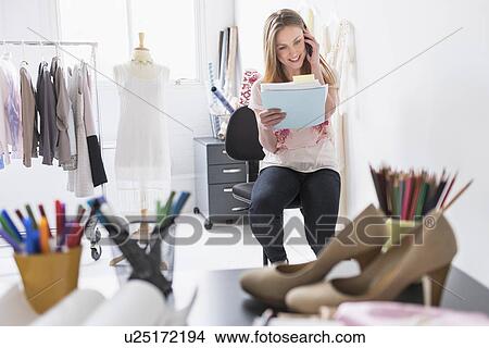 Portrait of female costume designer using mobile phone in studio View Large Photo Image Picture - Portrait of female costume designer using mobile phone in studio. Fotosearch