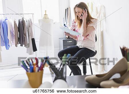 Portrait of female costume designer using mobile phone in studio View Large Photo Image Stock Photograph - Portrait of female costume designer using mobile phone in studio. Fotosearch