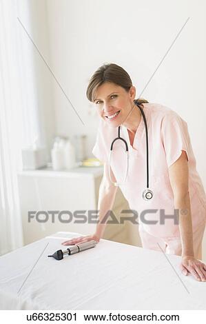 Stock Image - Portrait of female doctor. Fotosearch