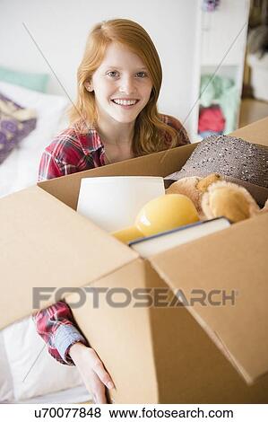 Portrait of girl (12-13) holding box View Large Photo Image Stock Photo - Portrait of girl (12-13) holding box. Fotosearch