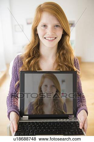Portrait of girl (12-13) holding laptop View Large Photo Image Stock Photo - Portrait of girl (12-13) holding laptop. Fotosearch