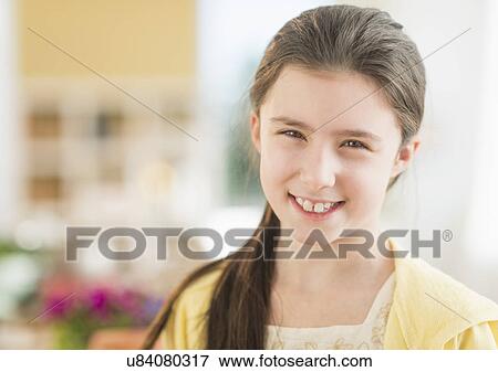 Stock Photo - Portrait of girl (8-9) smiling. Fotosearch