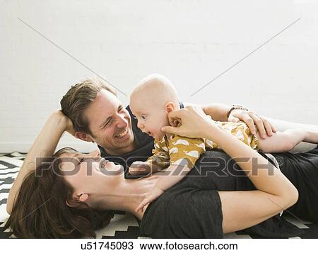 Portrait of parents with baby son (2-5 months) View Large Photo Image Stock Image - Portrait of parents with baby son (2-5 months). Fotosearch