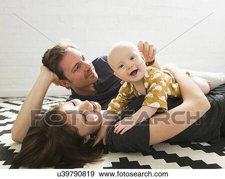 Portrait of parents with baby son (2-5 months) View Large Photo Image Stock Photo - Portrait of parents with baby son (2-5 months). Fotosearch