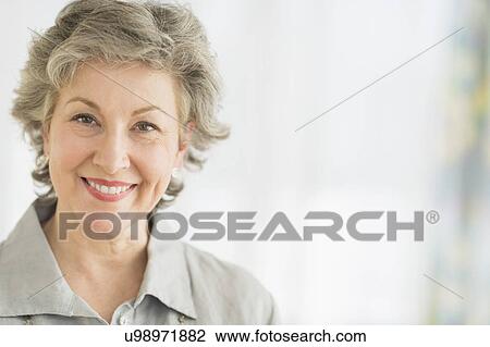 Stock Image - Portrait of smiling woman. Fotosearch