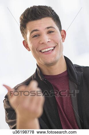 Portrait of smiling young man View Large Photo Image Stock Photo - Portrait of smiling young man. Fotosearch