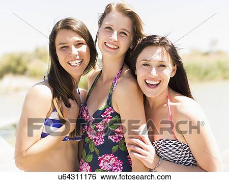 Stock Photograph - Portrait of three women on beach. Fotosearch