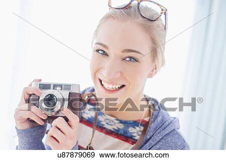 Portrait of woman holding camera View Large Photo Image Stock Photo - Portrait of woman holding camera. Fotosearch