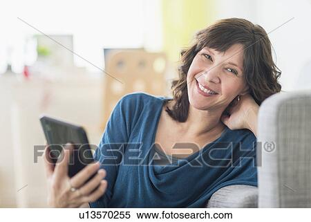 Portrait of woman holding tablet pc View Large Photo Image Stock Photography - Portrait of woman holding tablet pc. Fotosearch