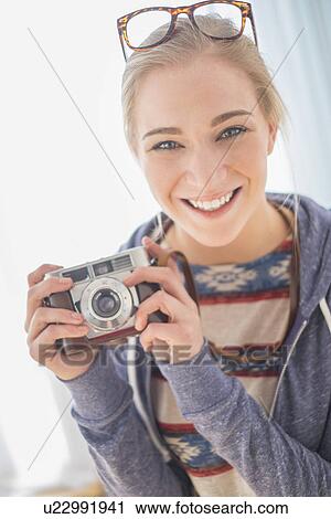 Portrait of woman holding vintage camera View Large Photo Image Stock Image - Portrait of woman holding vintage camera. Fotosearch