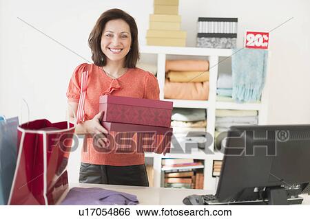Portrait of woman in clothes store View Large Photo Image Stock Photograph - Portrait of woman in clothes store. Fotosearch