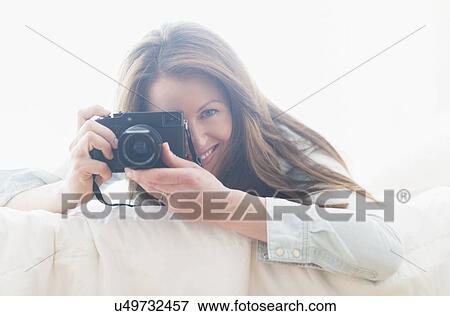 Stock Photo - Portrait of woman photographing. Fotosearch