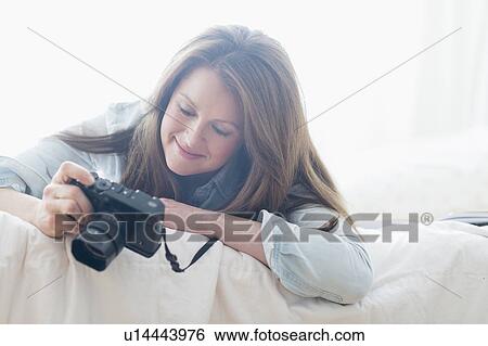 Stock Photograph - Portrait of woman photographing. Fotosearch