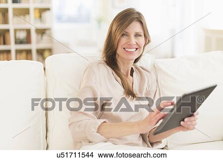 Picture - Portrait of woman using tablet pc. Fotosearch