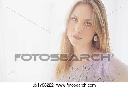 Stock Image - Portrait of young blond woman. Fotosearch