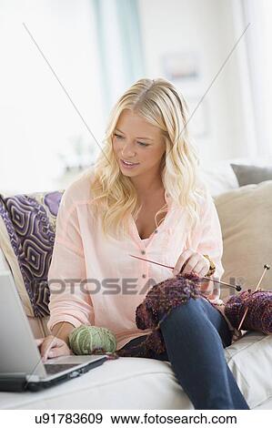 Stock Photo - Portrait of young woman learning knitting. Fotosearch
