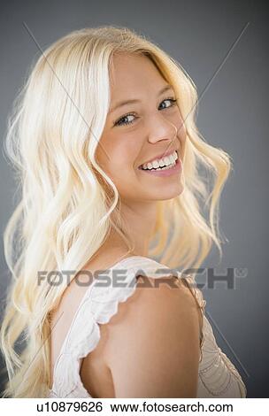 Stock Photograph - Portrait of young woman smiling. Fotosearch