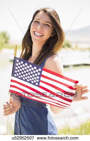 Portrait of young woman with american flag View Large Photo Image Stock Photo - Portrait of young woman with american flag. Fotosearch